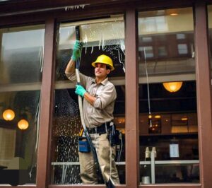 Shopping center window cleaning in Texas by an employee of a janitorial company